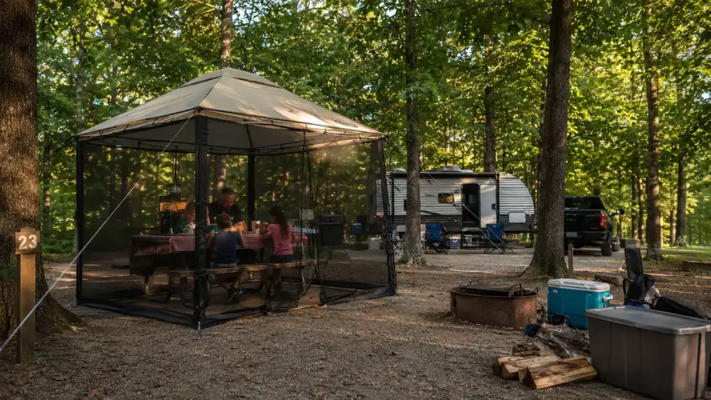 Alvantor pop up screen house set up at a campsite picnic table with mesh walls visible